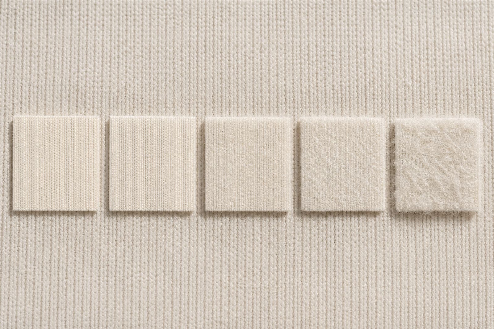 Squares of the same fabric showing progressively more surface fuzz